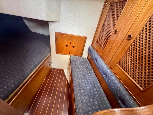 Interior of 1984 Camper & Nicholsons Nicholson 35 sailboat with wooden cabinetry and seating.