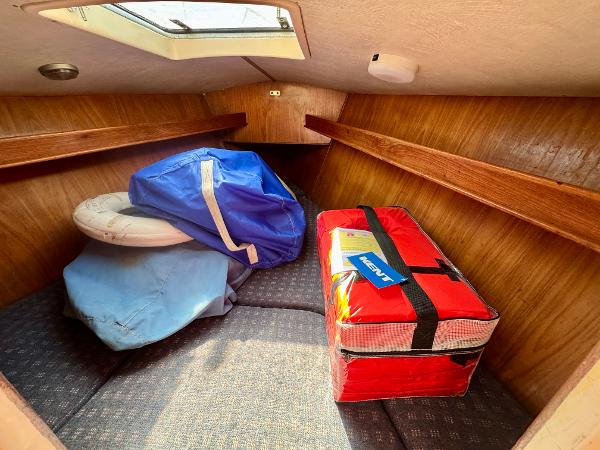 Interior cabin of 1984 Camper & Nicholsons Nicholson 35 sailboat with storage items.