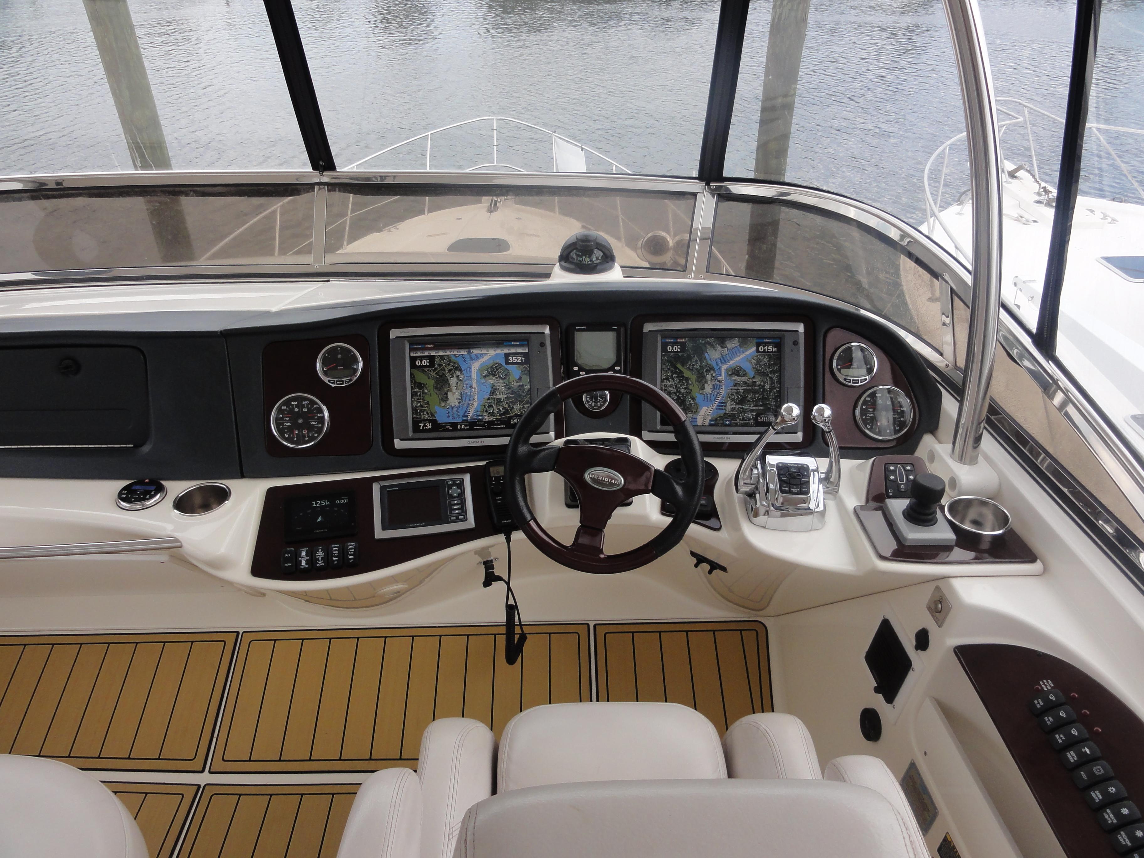 Meridian-441 Sedan 2009-Be Lisamo RI-US-2009 Meridian 441 Sedan helm with navigation screens and controls, docked by the water.-9714633 | Thumbnail