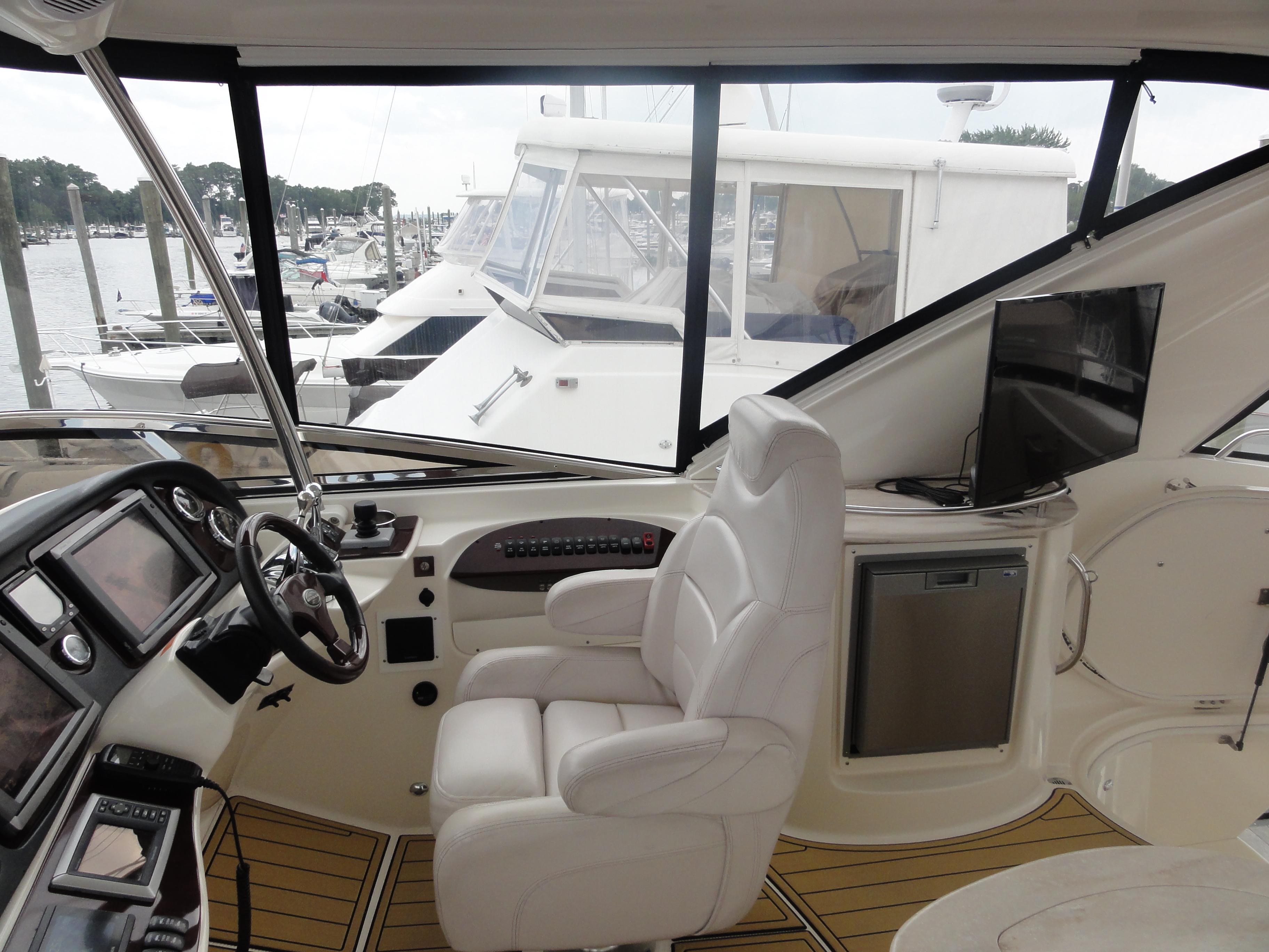 Meridian-441 Sedan 2009-Be Lisamo RI-US-Interior of 2009 Meridian 441 Sedan yacht with helm, seating, and marina view.-9714633 | Thumbnail