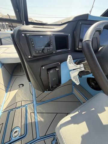 Interior of 2025 Centurion Fe25 boat with modern dashboard and steering wheel.