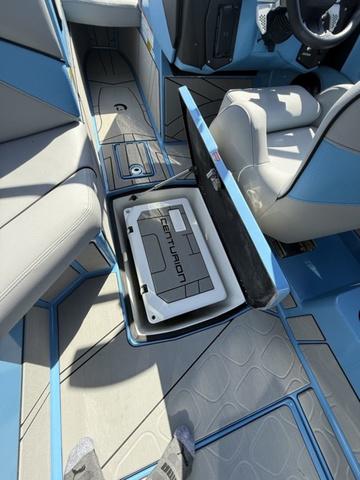 2025 Centurion Fe25 boat interior with open storage compartment and seating.