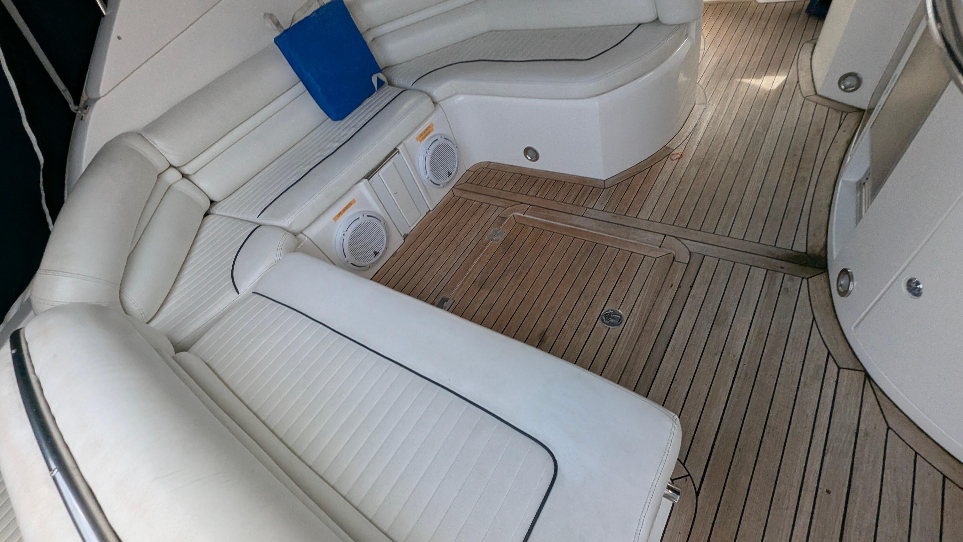 Luxurious 2004 Sunseeker Portofino yacht interior with white seating and wooden flooring.