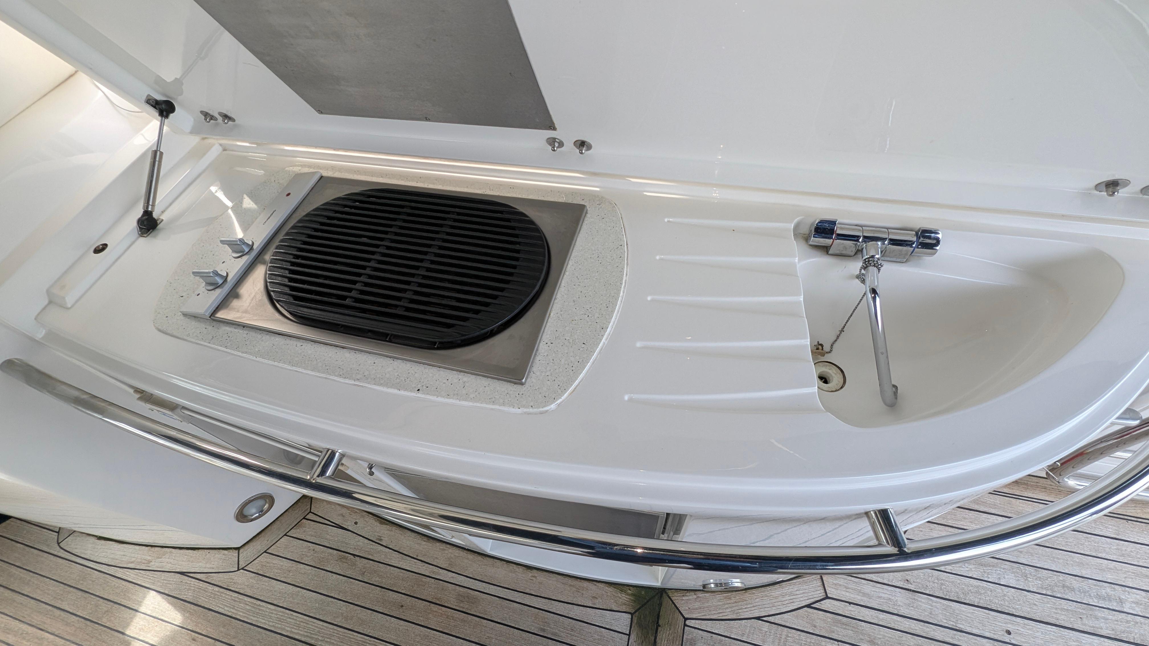 2004 Sunseeker Portofino yacht deck with built-in grill and sink.