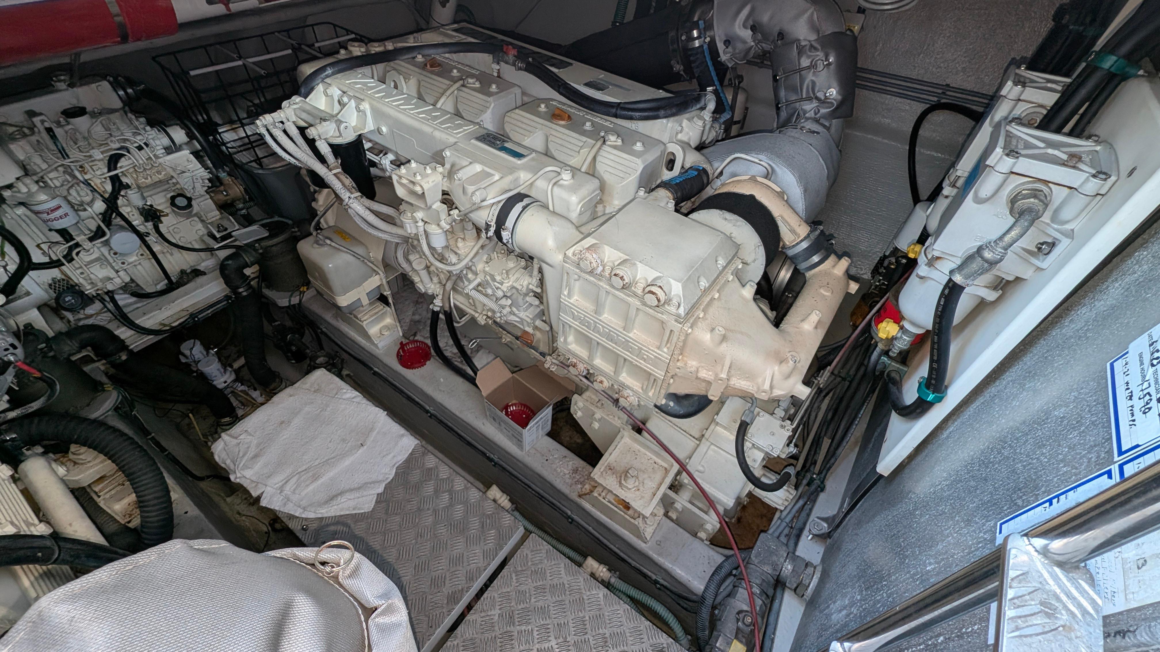 Engine room of a 2004 Sunseeker Portofino yacht, showcasing detailed machinery and components.
