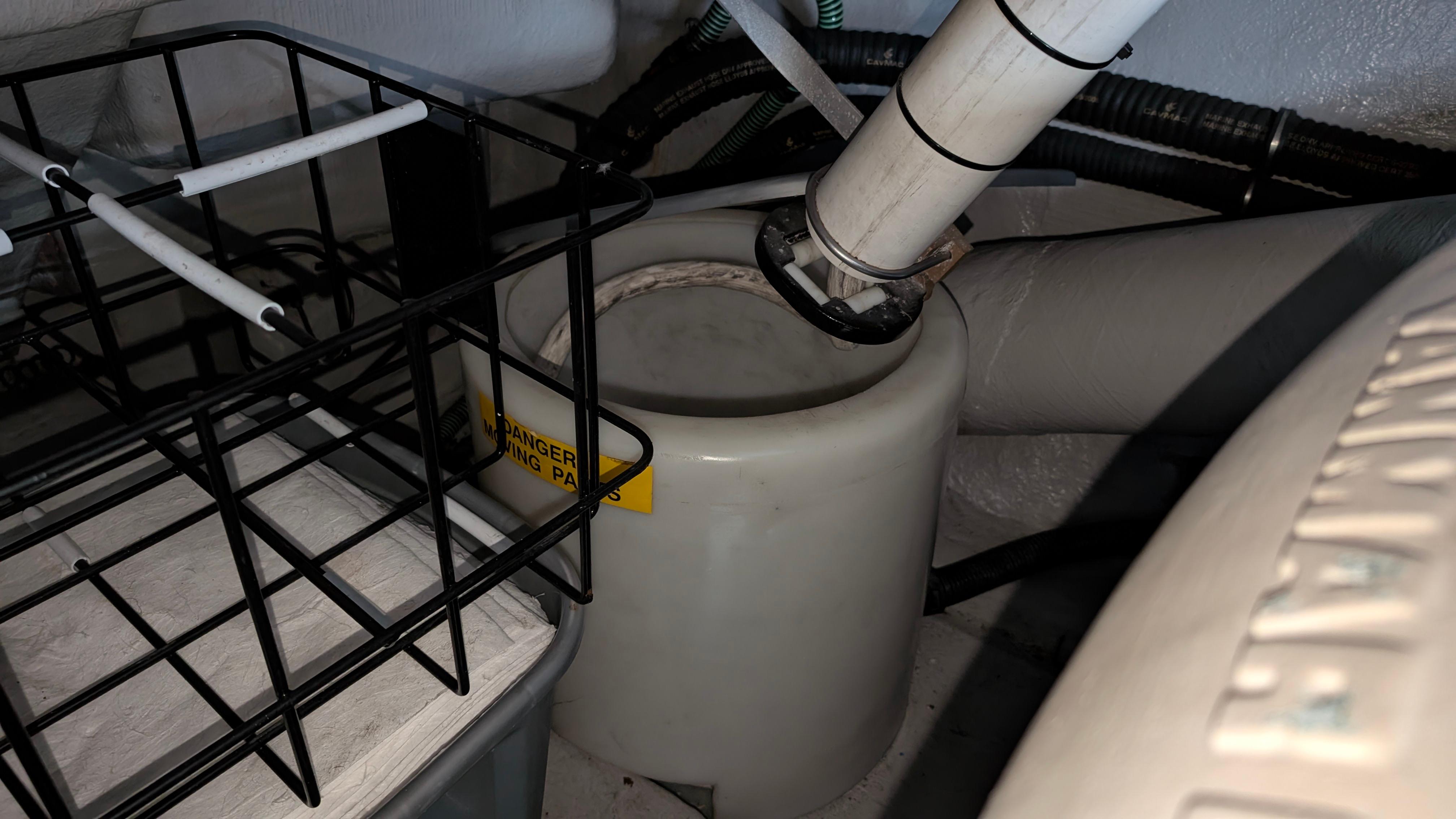 Engine compartment of a 2004 Sunseeker Portofino yacht, featuring mechanical components and storage.