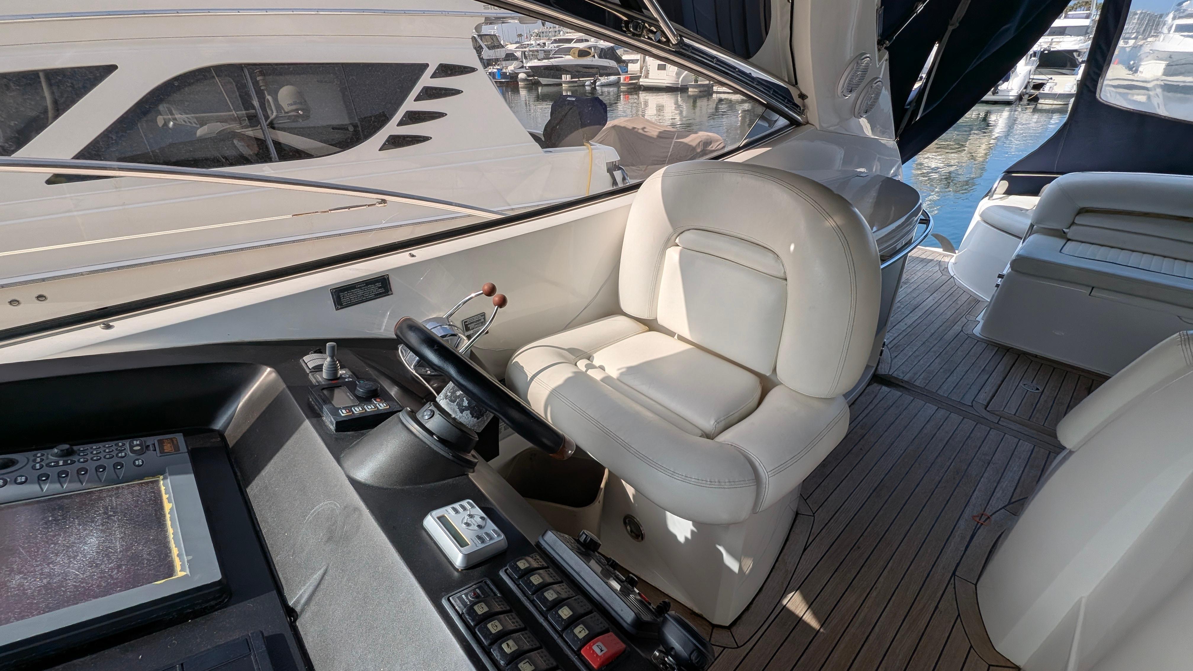 2004 Sunseeker Portofino yacht cockpit with leather seating and control panel.