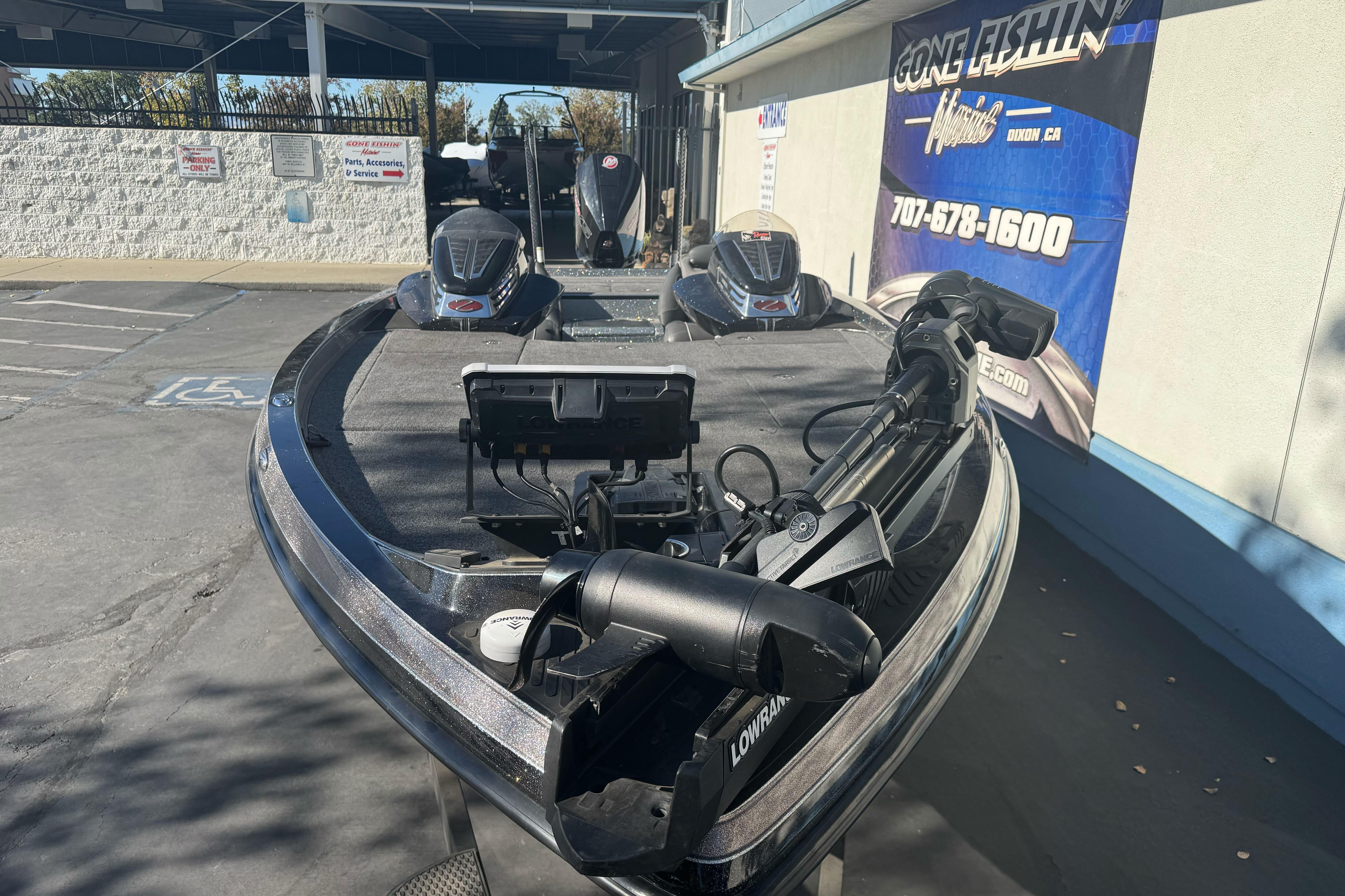 2020 Ranger Z521C Ranger Cup Equipped boat with advanced fishing gear in a dealership lot.