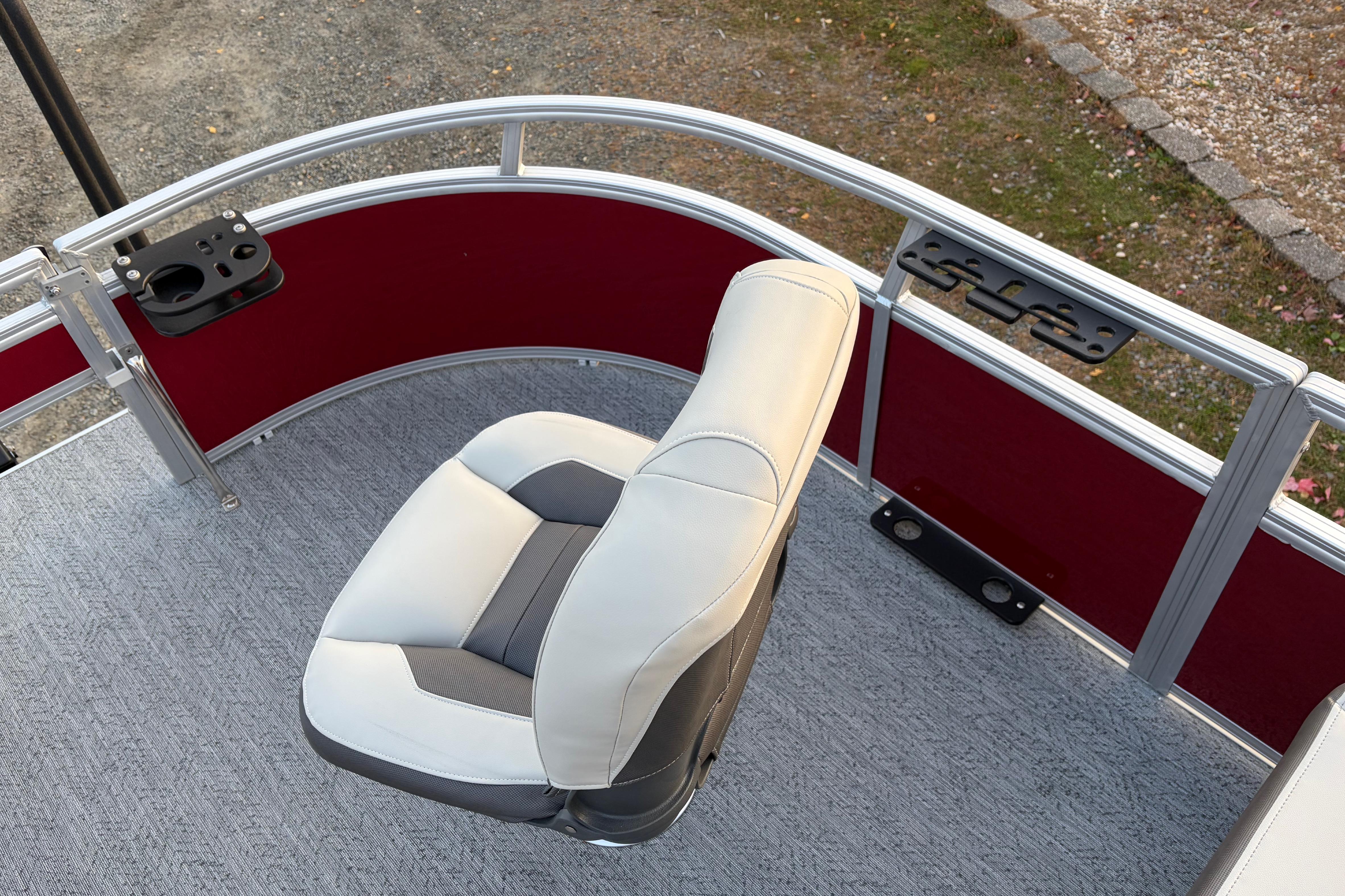 2026 Sun Tracker Bass Buggy 16 XL Select boat seat with red paneling and fishing rod holders.