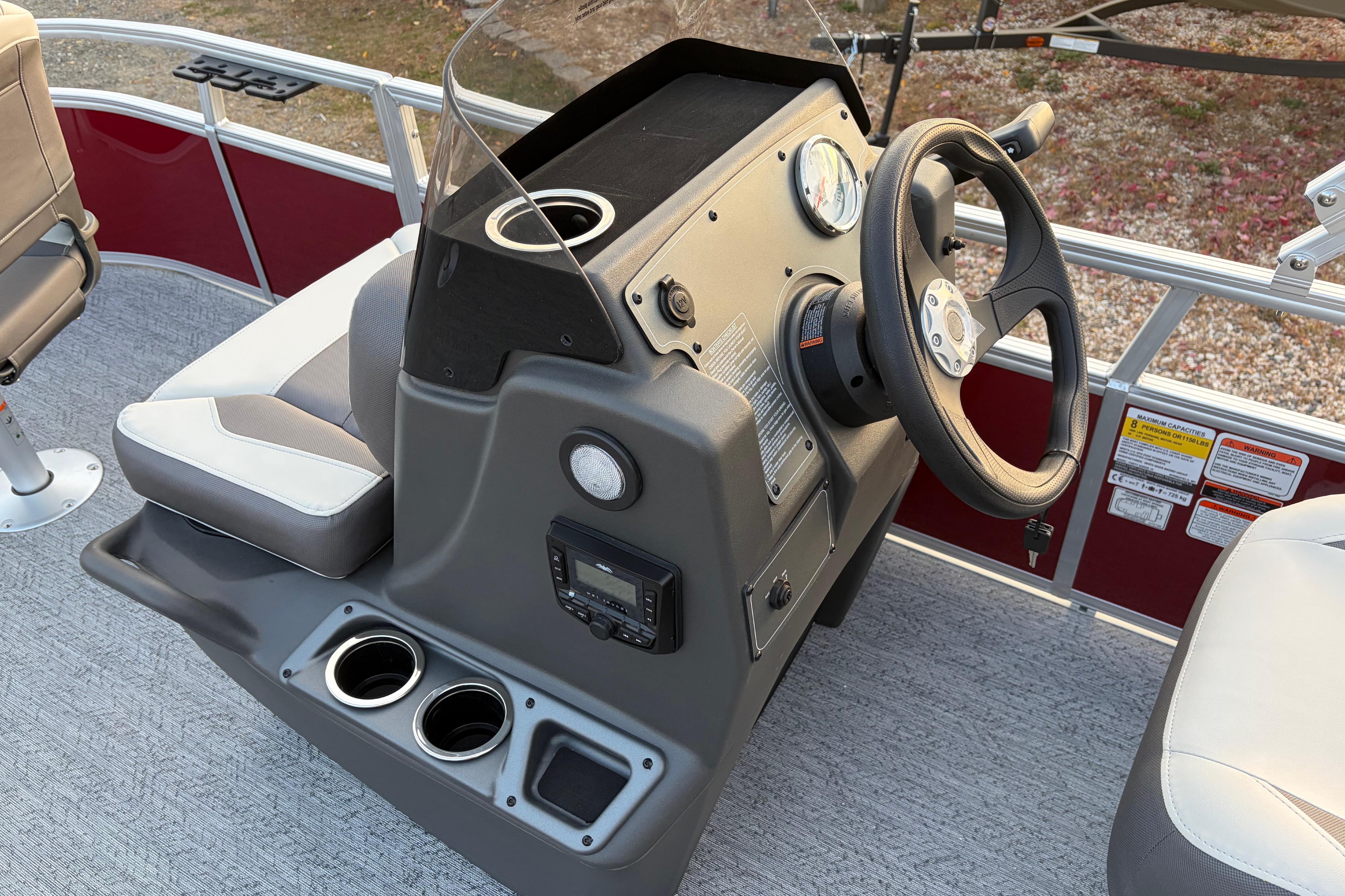 2026 Sun Tracker Bass Buggy 16 XL Select boat console with steering wheel and seating.