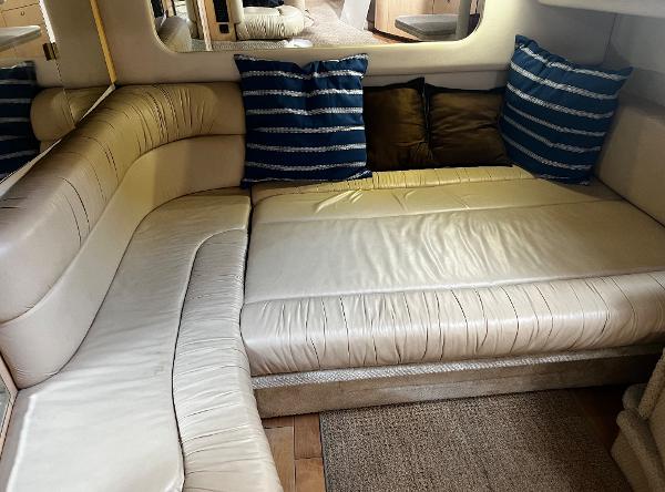 Interior of 2000 Sea Ray 380 Sundancer with cream leather seating and striped cushions.