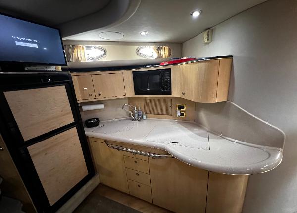 Interior of a 2000 Sea Ray 380 Sundancer yacht kitchen with modern amenities.