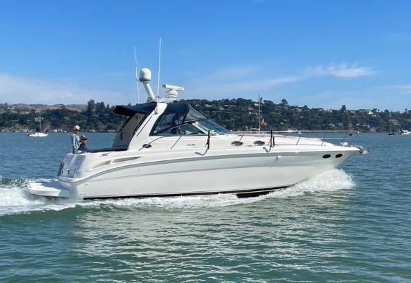 2000 Sea Ray 380 Sundancer cruising on a sunny day in calm waters.