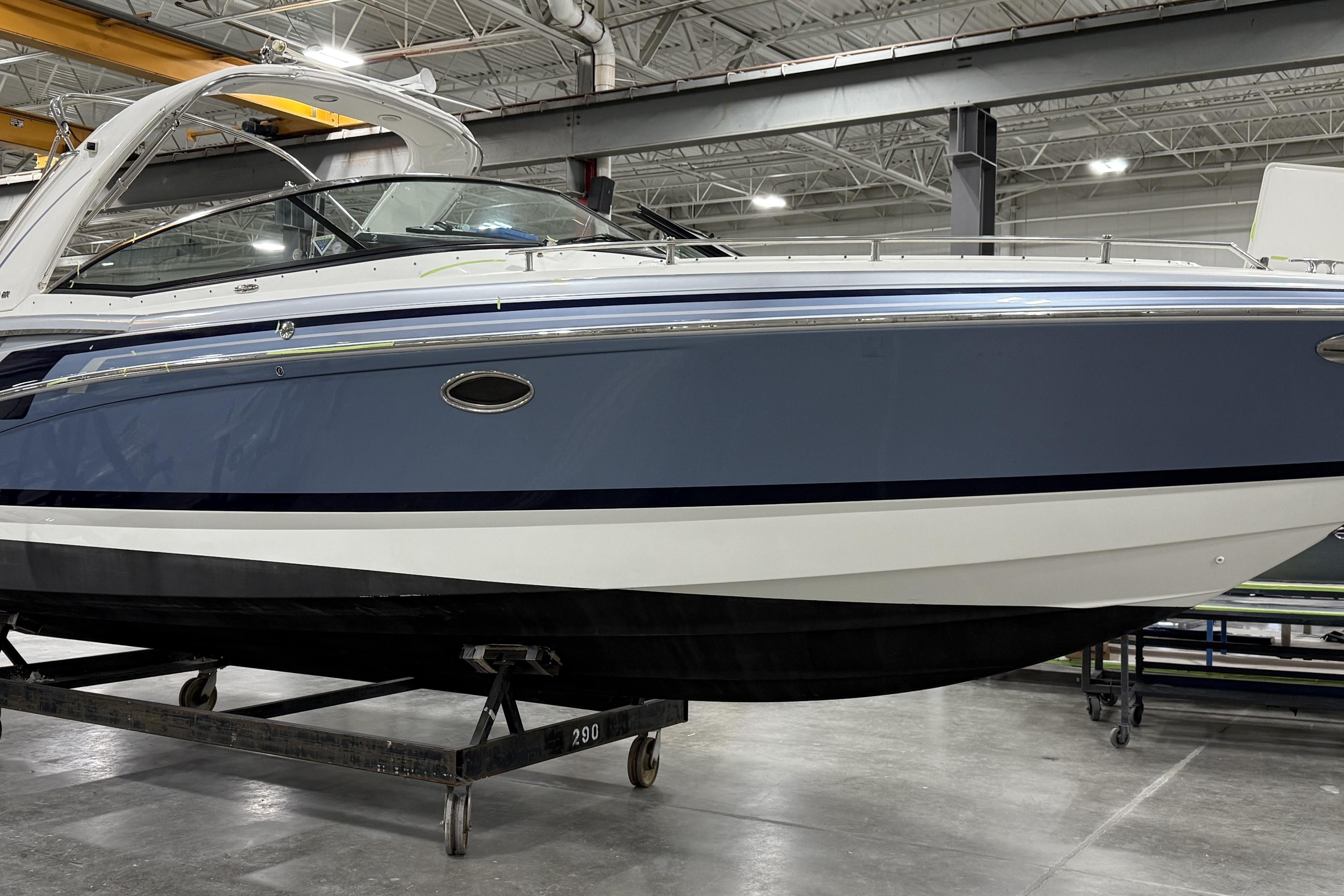 2020 Formula 310 Bowrider boat in a warehouse, side view.