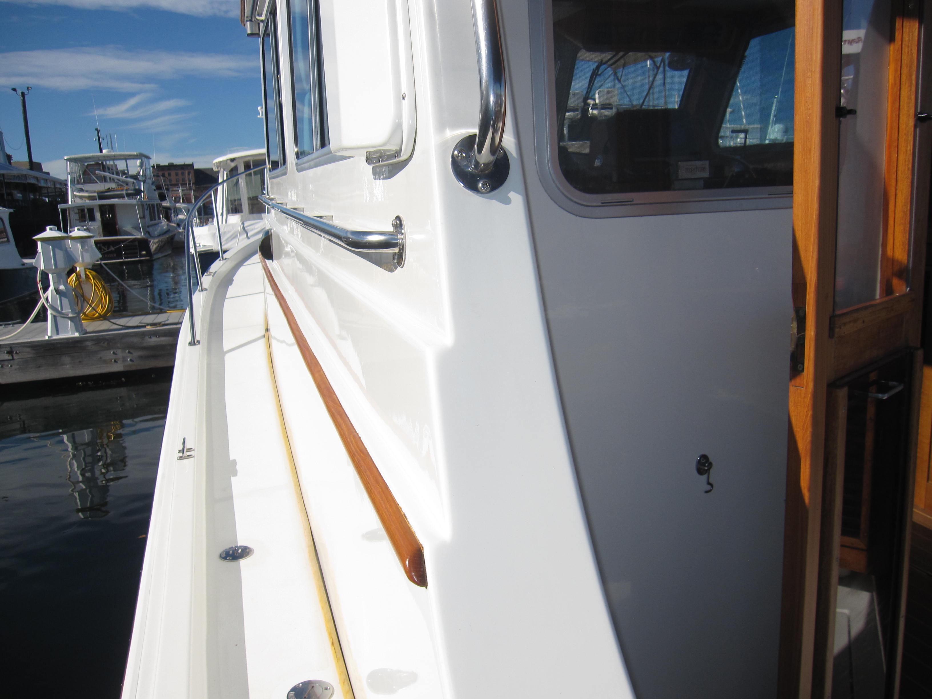 Side view of 1990 Blue Seas 31 Hardtop Cruiser docked at marina.