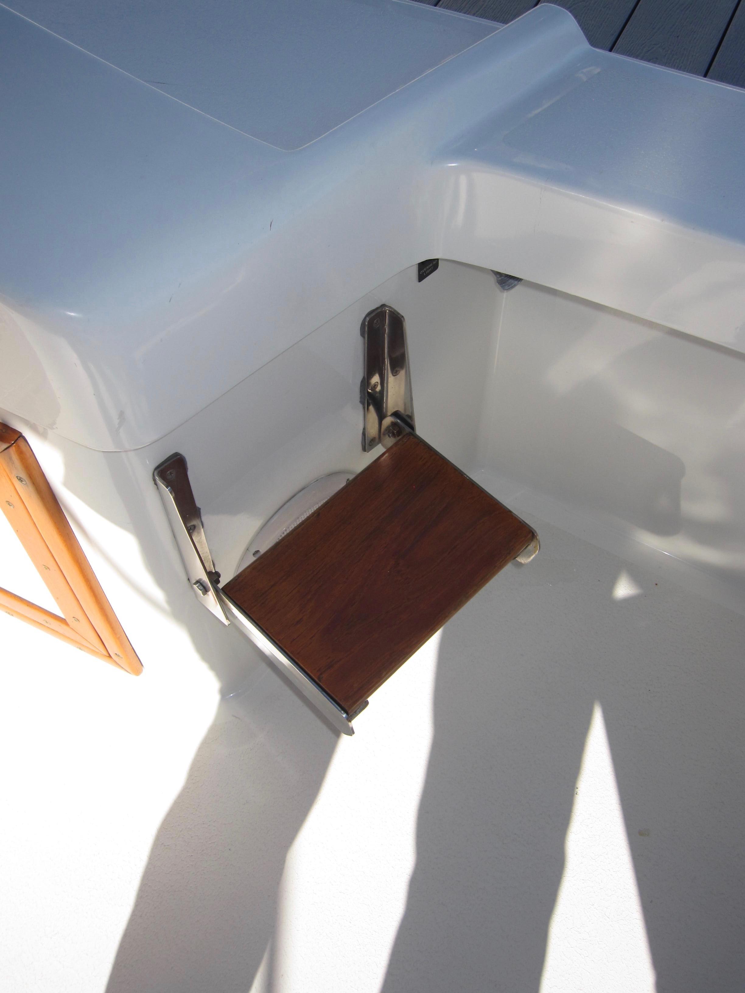 Foldable wooden seat on a 1990 Blue Seas 31 Hardtop Cruiser.