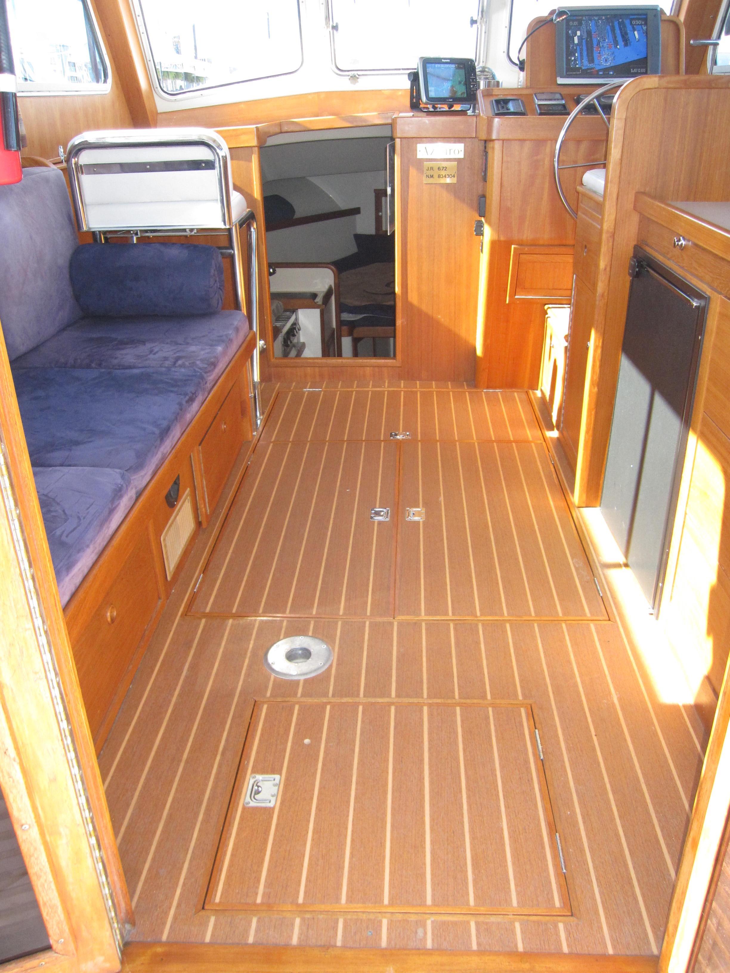 Interior of a 1990 Blue Seas 31 Hardtop Cruiser with wooden flooring and seating.