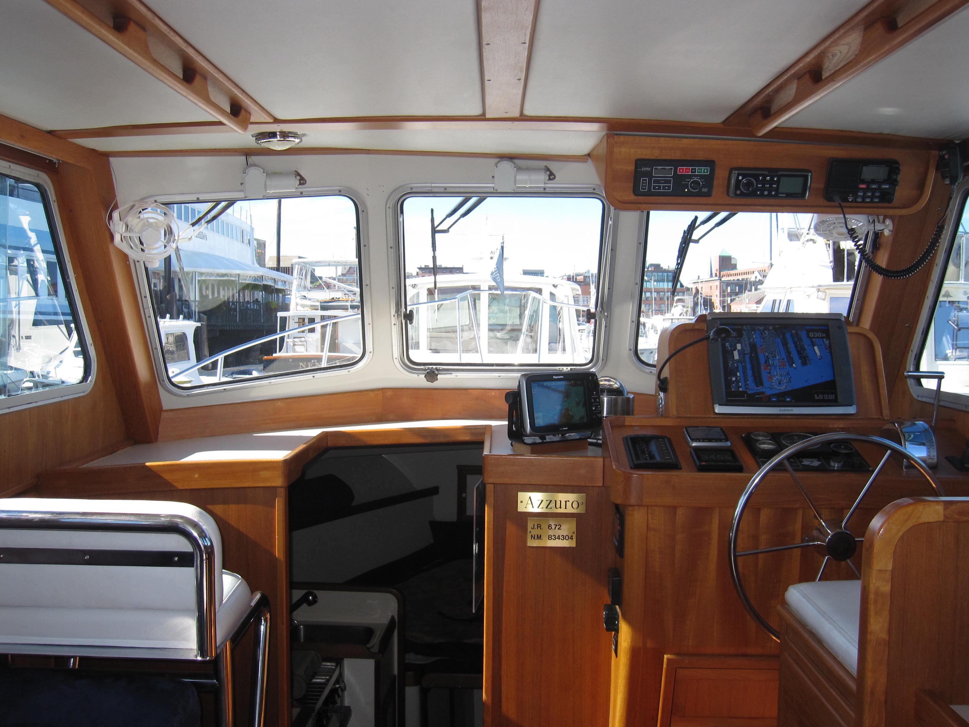 1990 Blue Seas 31 Hardtop Cruiser interior with navigation equipment and helm station.
