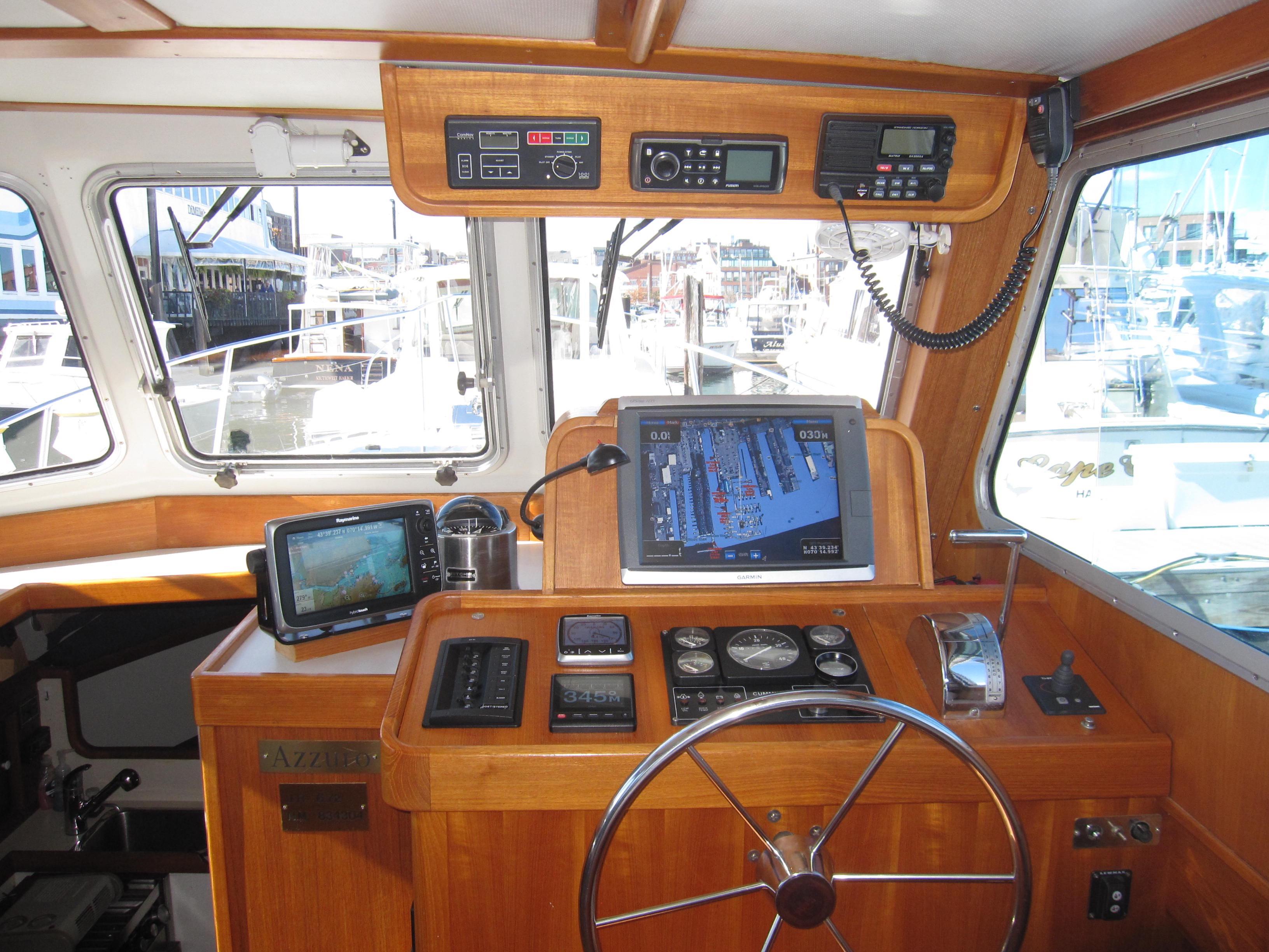Interior helm of a 1990 Blue Seas 31 Hardtop Cruiser with navigation equipment.