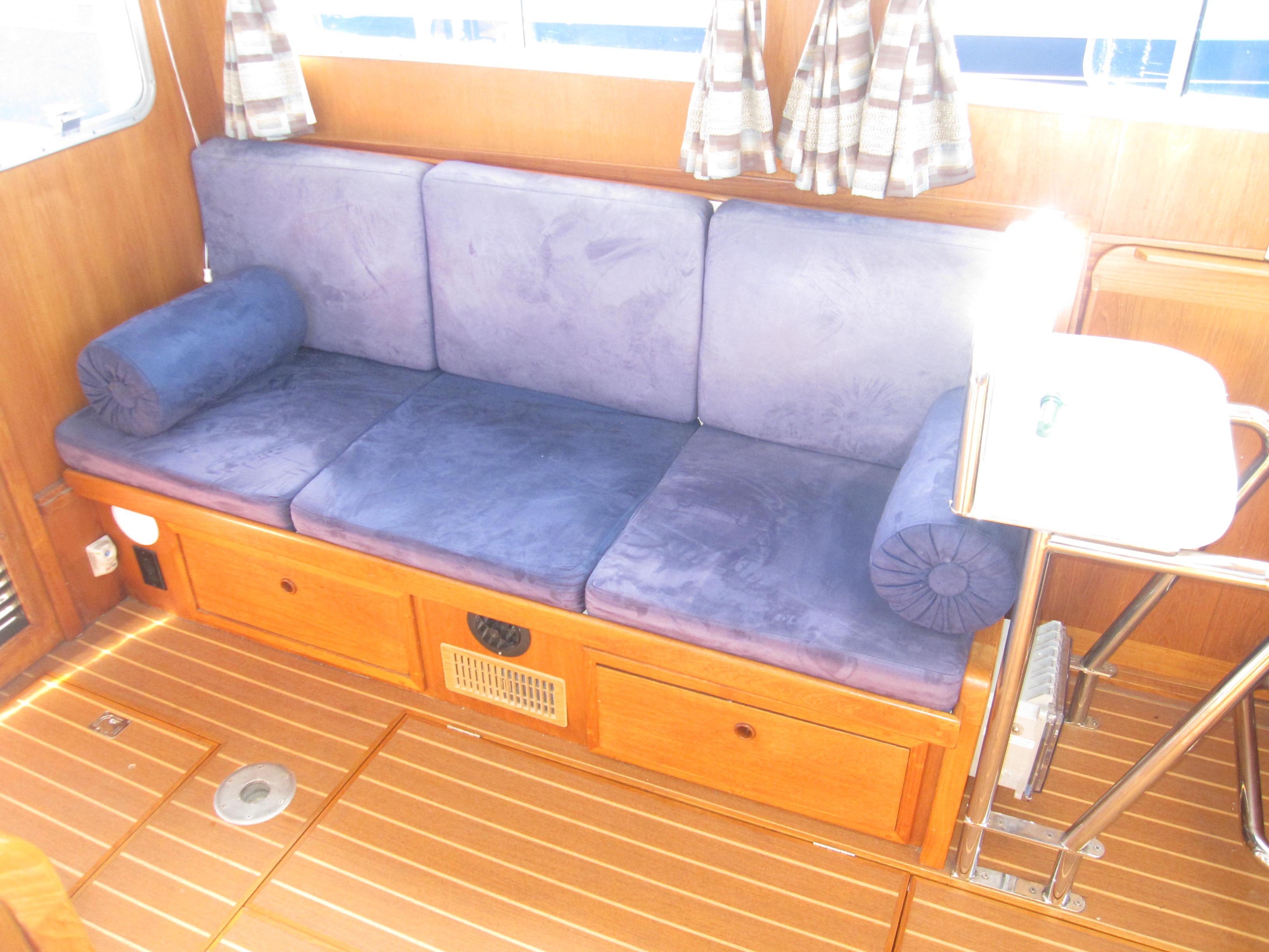 Interior seating of a 1990 Blue Seas 31 Hardtop Cruiser with blue cushions.