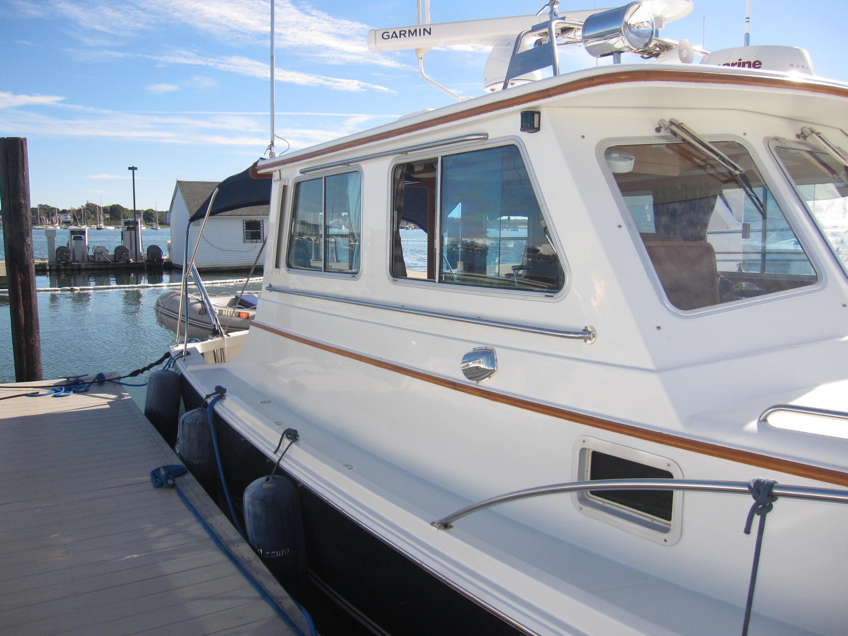 1990 Blue Seas 31 Hardtop Cruiser docked at a marina.