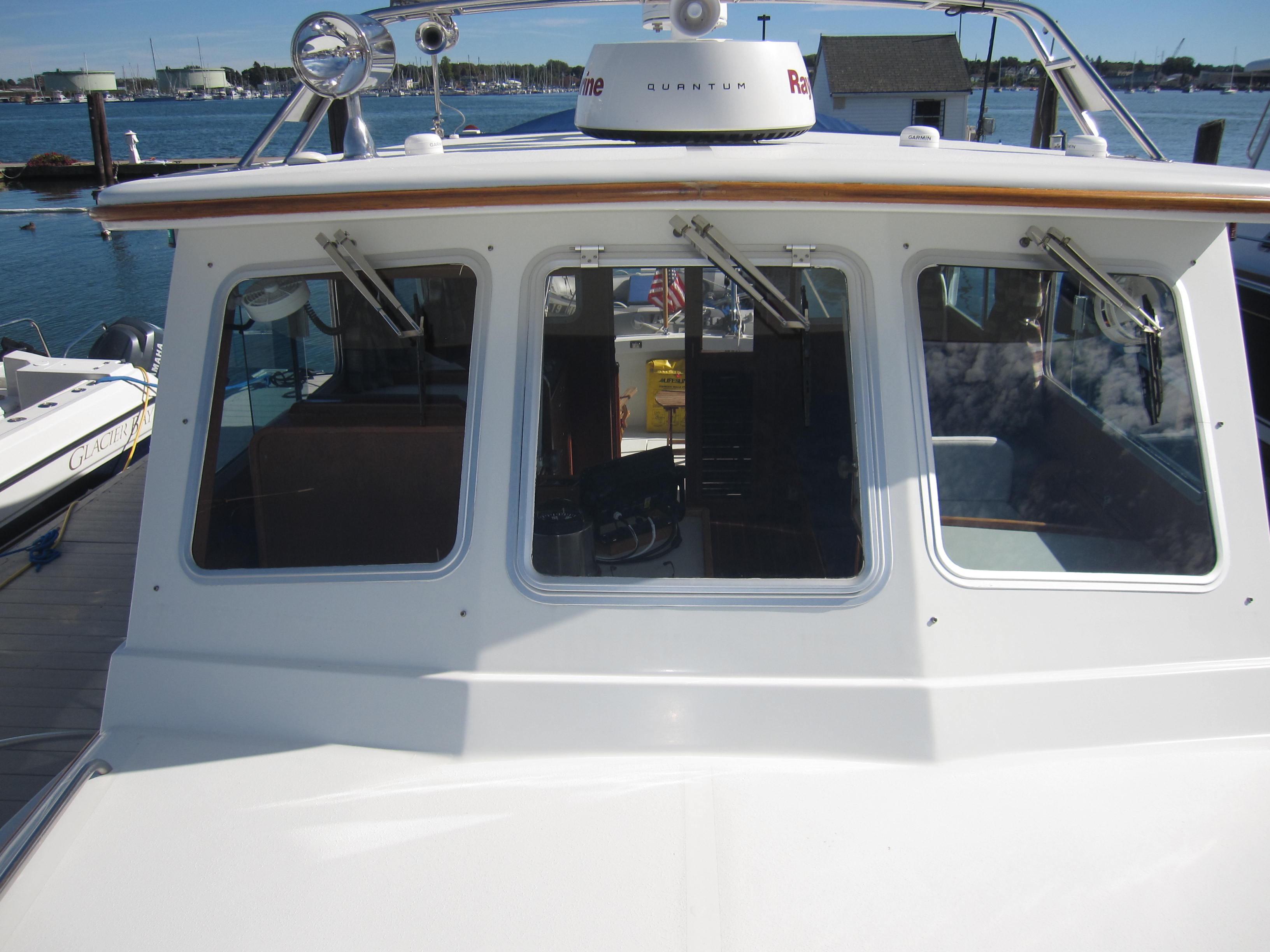 1990 Blue Seas 31 Hardtop Cruiser boat docked at marina.