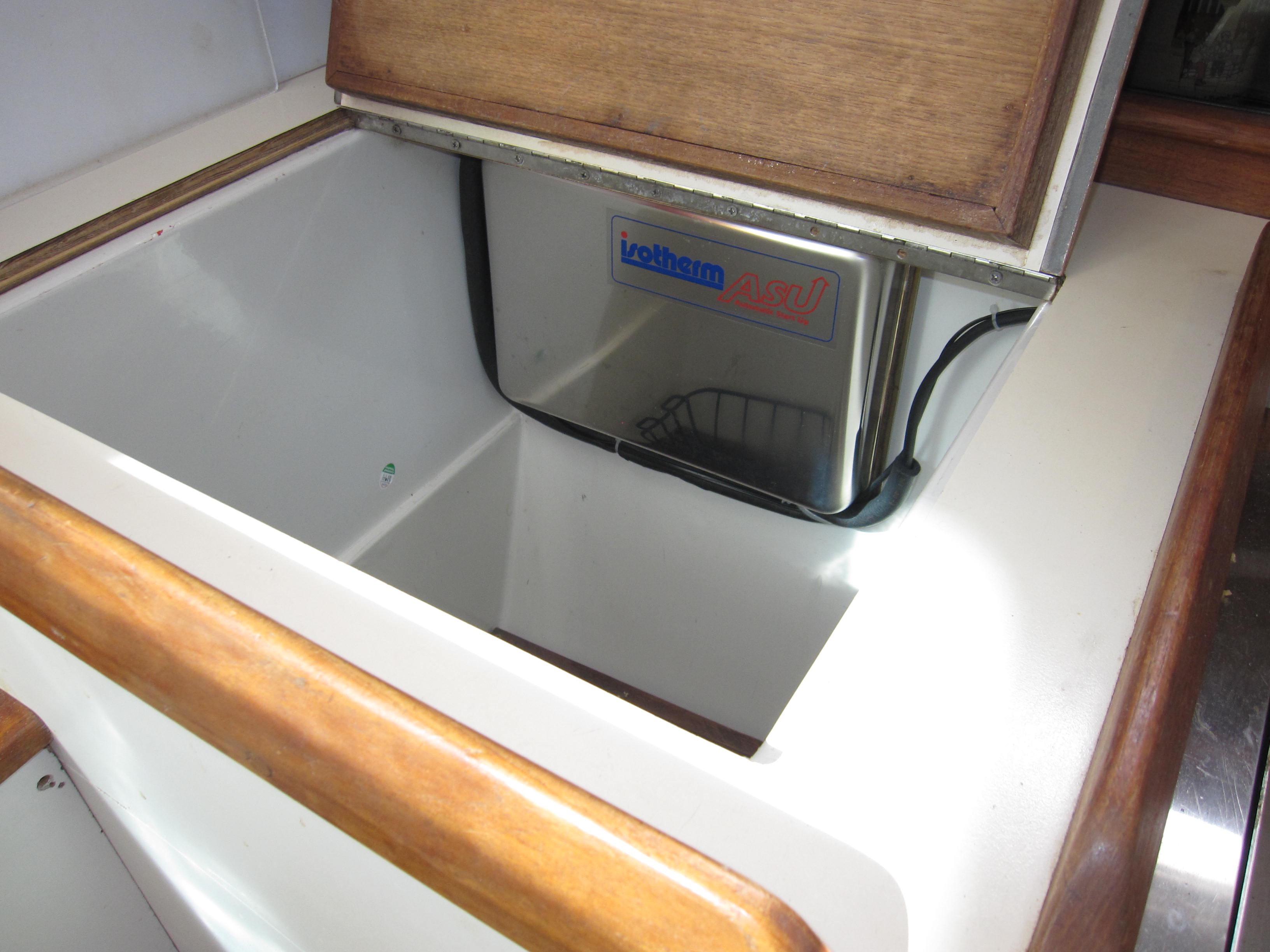 Interior of 1990 Blue Seas 31 Hardtop Cruiser showing storage compartment.