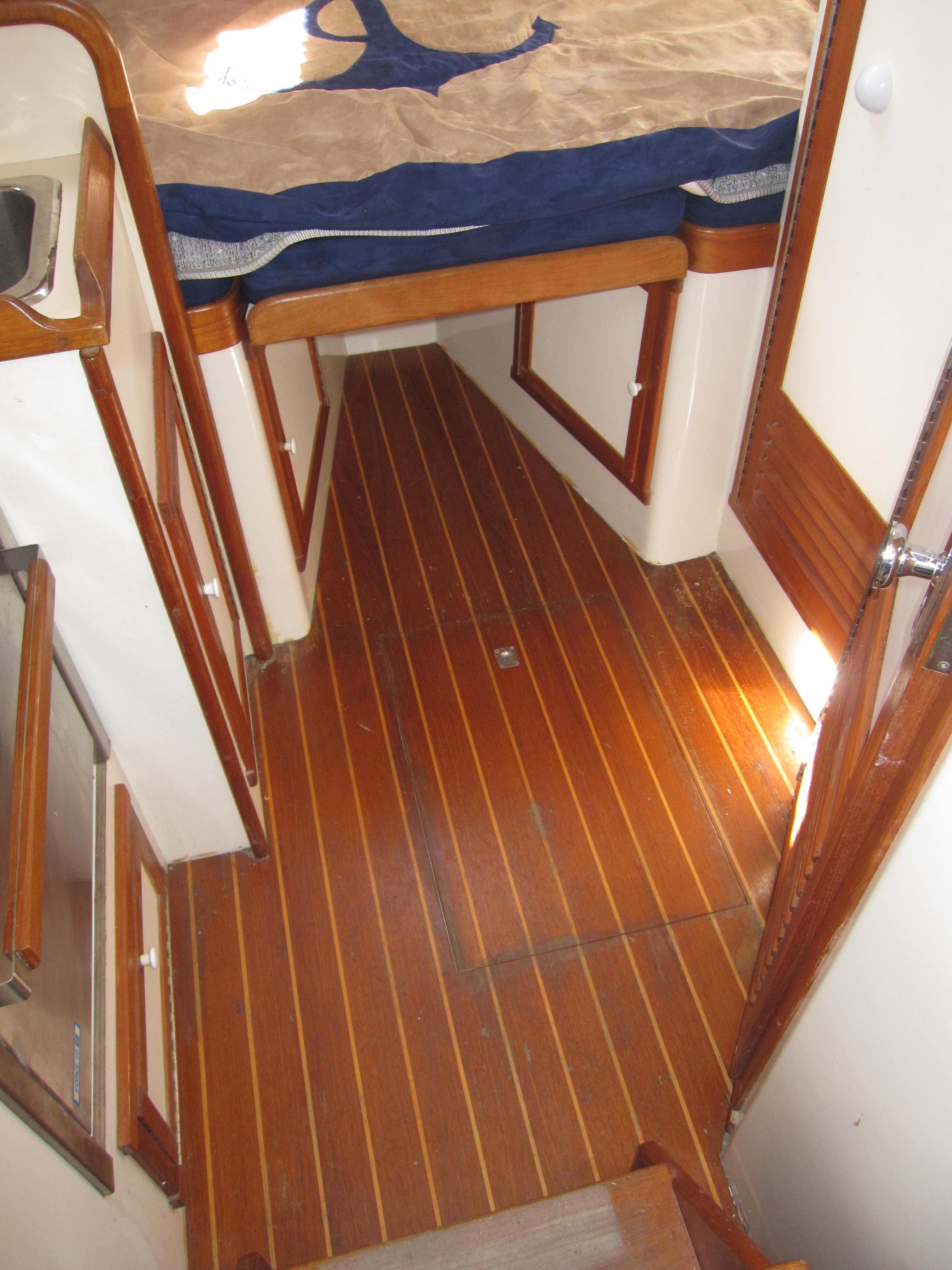 1990 Blue Seas 31 Hardtop Cruiser interior with wooden flooring and cozy cabin.