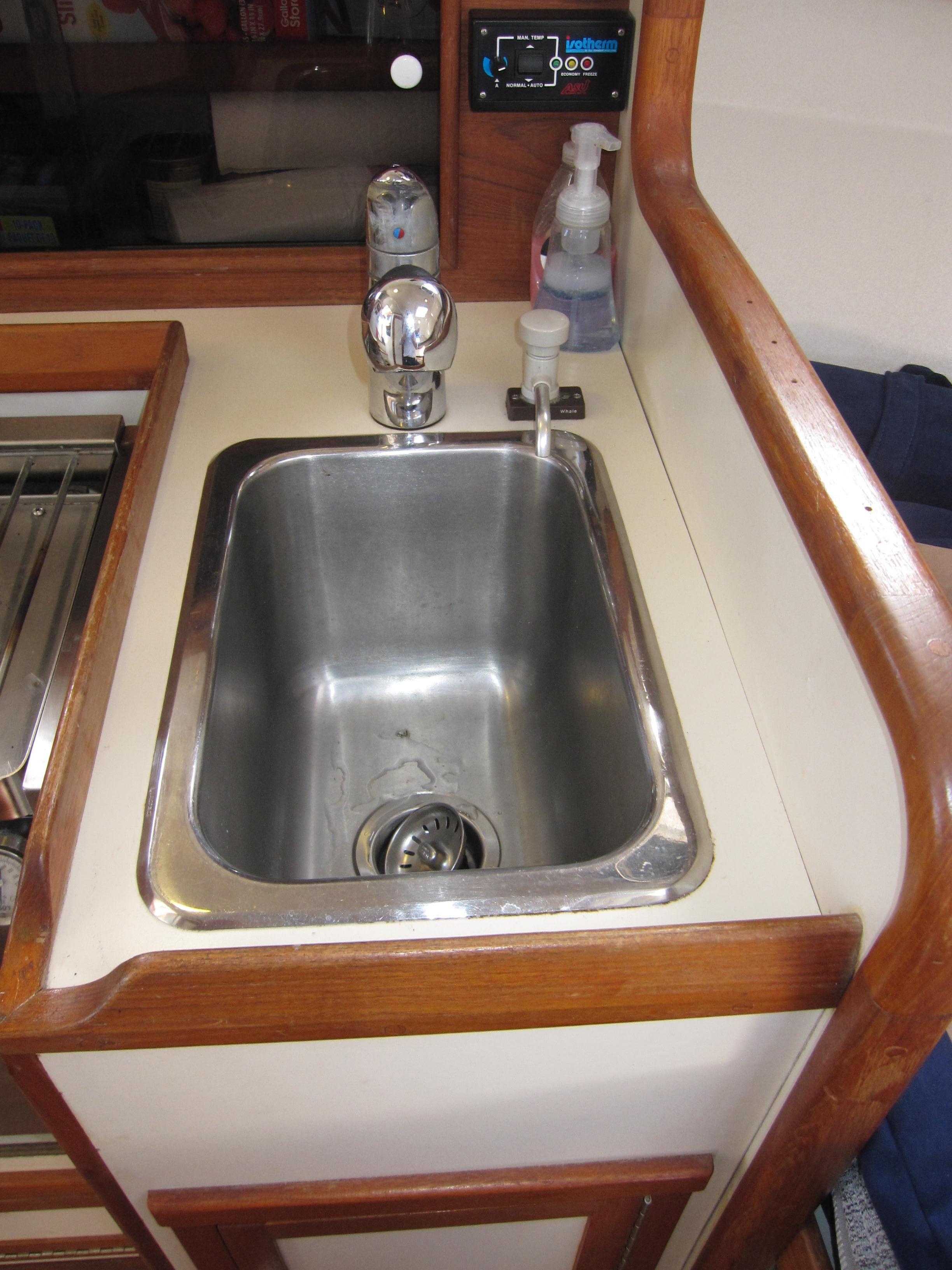 1990 Blue Seas 31 Hardtop Cruiser kitchen sink with faucet and soap dispenser.