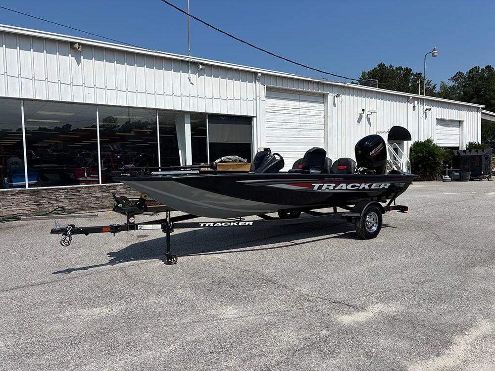 2025 Tracker Pro Team 175 Crappie Edition boat on trailer outside dealership.