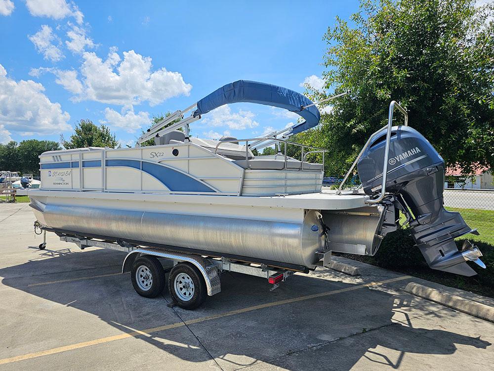 2022 Bennington 22 SXSB pontoon boat with Yamaha outboard motor on a trailer.