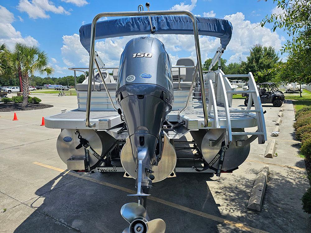 2022 Bennington 22 SXSB pontoon boat with Yamaha 150 engine, parked outdoors.