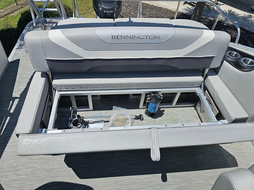 2022 Bennington 22 SXSB boat interior with open storage compartment and seating.