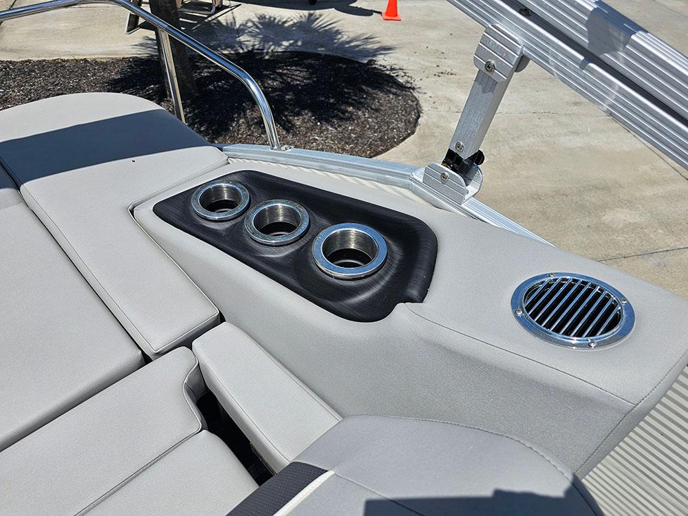 2022 Bennington 22 SXSB boat interior with cup holders and speaker on gray seating.