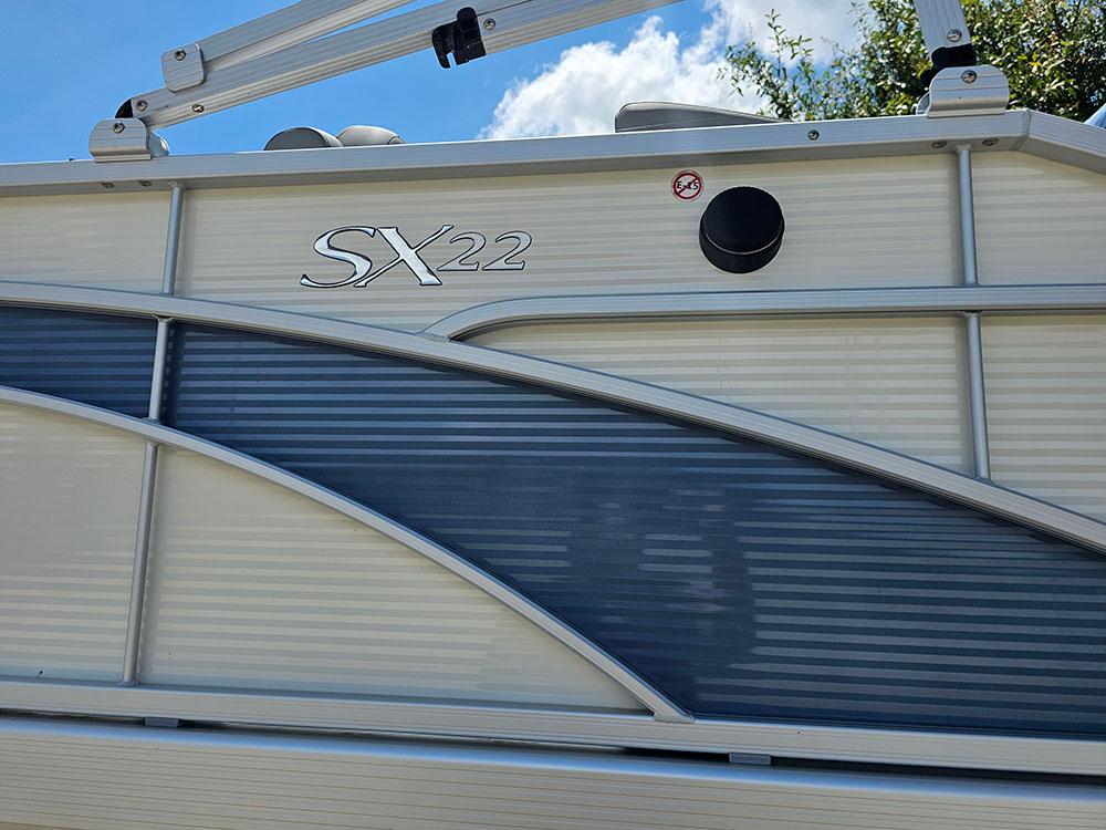 2022 Bennington 22 SXSB boat side view with sleek design and logo.