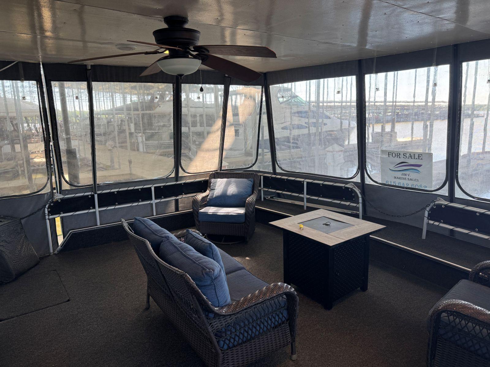 Stardust Cruisers-18 X 80 Houseboat 1986 -TN-US-Enclosed deck of 1986 Stardust Cruisers 18 X 80 houseboat with seating and ceiling fan.-9804797 | Thumbnail