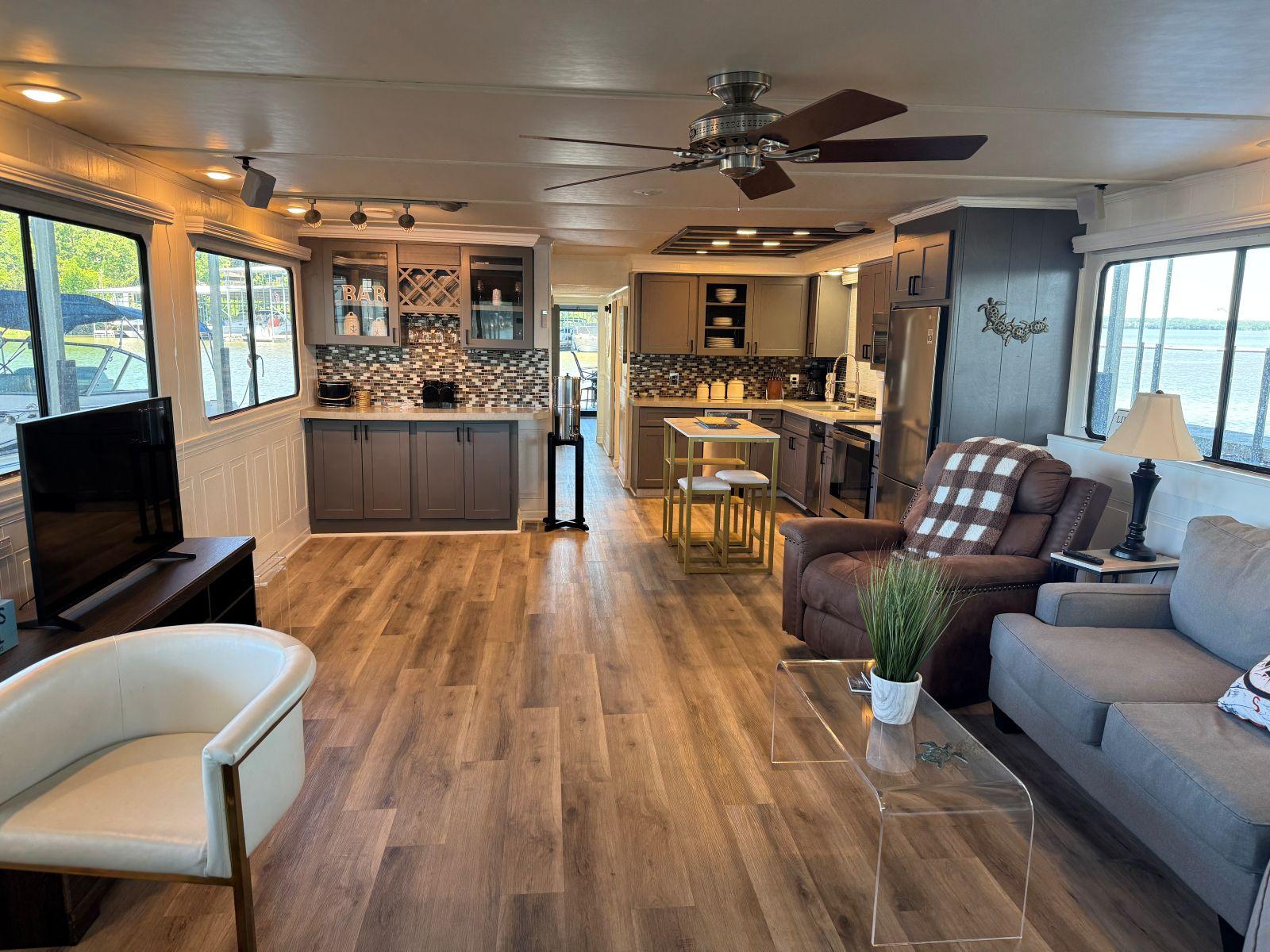 Stardust Cruisers-18 X 80 Houseboat 1986 -TN-US-Spacious 1986 Stardust Cruisers houseboat interior with modern kitchen, cozy seating, and wood flooring.-9804797 | Thumbnail