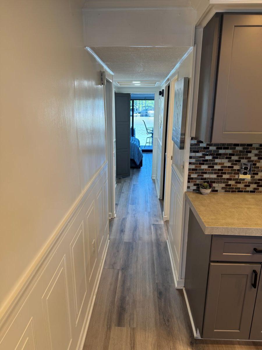 Stardust Cruisers-18 X 80 Houseboat 1986 -TN-US-Narrow hallway in a 1986 Stardust Cruisers 18 X 80 houseboat, featuring modern kitchen cabinetry.-9804797 | Thumbnail