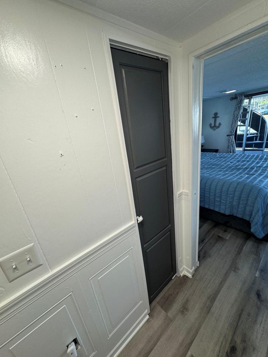 Stardust Cruisers-18 X 80 Houseboat 1986 -TN-US-1986 Stardust Cruisers houseboat interior with bedroom, wood flooring, and nautical decor.-9804797 | Thumbnail