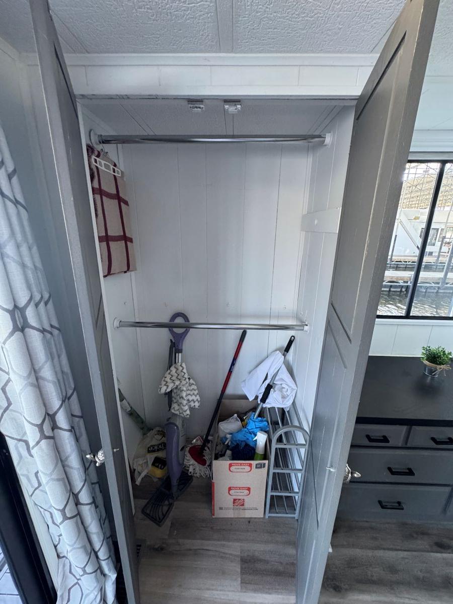 Stardust Cruisers-18 X 80 Houseboat 1986 -TN-US-Closet interior on 1986 Stardust Cruisers houseboat, featuring cleaning supplies and storage items.-9804797 | Thumbnail
