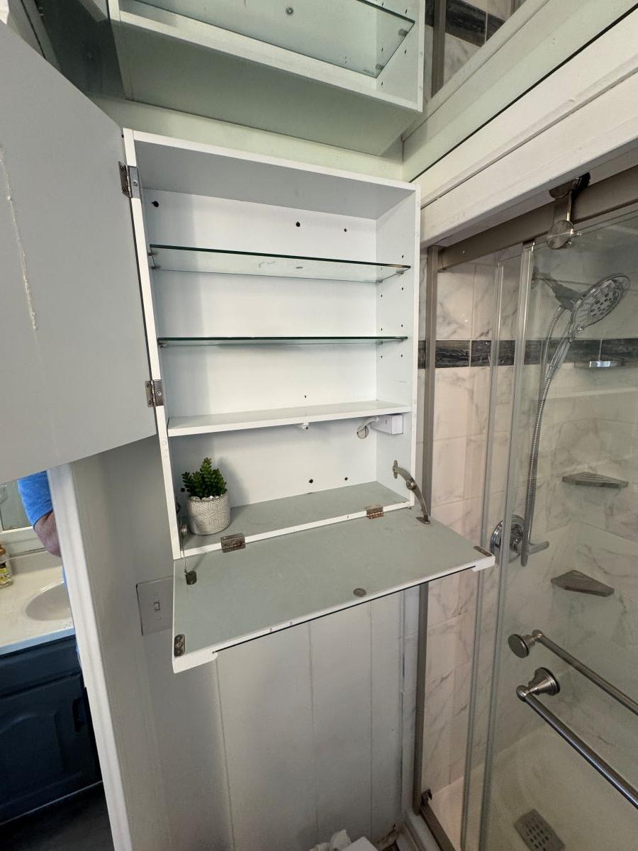 Stardust Cruisers-18 X 80 Houseboat 1986 -TN-US-Open bathroom cabinet with glass shelves in a 1986 Stardust Cruisers houseboat.-9804797 | Thumbnail
