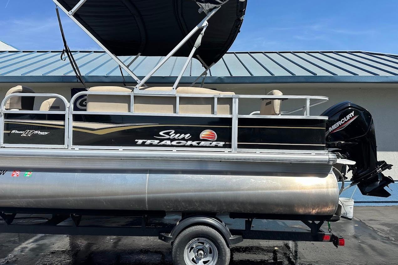 2022 Sun Tracker Bass Buggy 18 DLX pontoon boat with Mercury outboard motor.