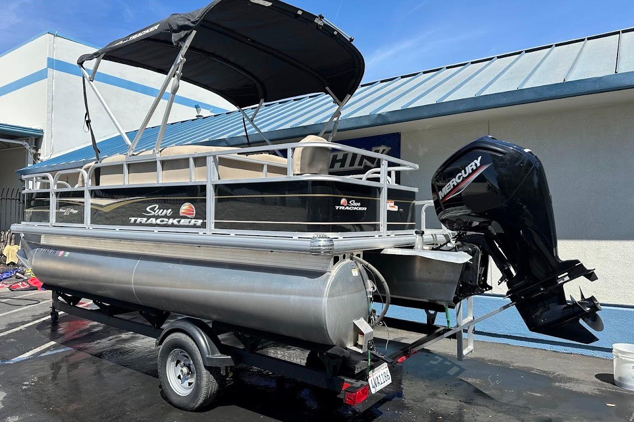 2022 Sun Tracker Bass Buggy 18 DLX pontoon boat with Mercury outboard motor.