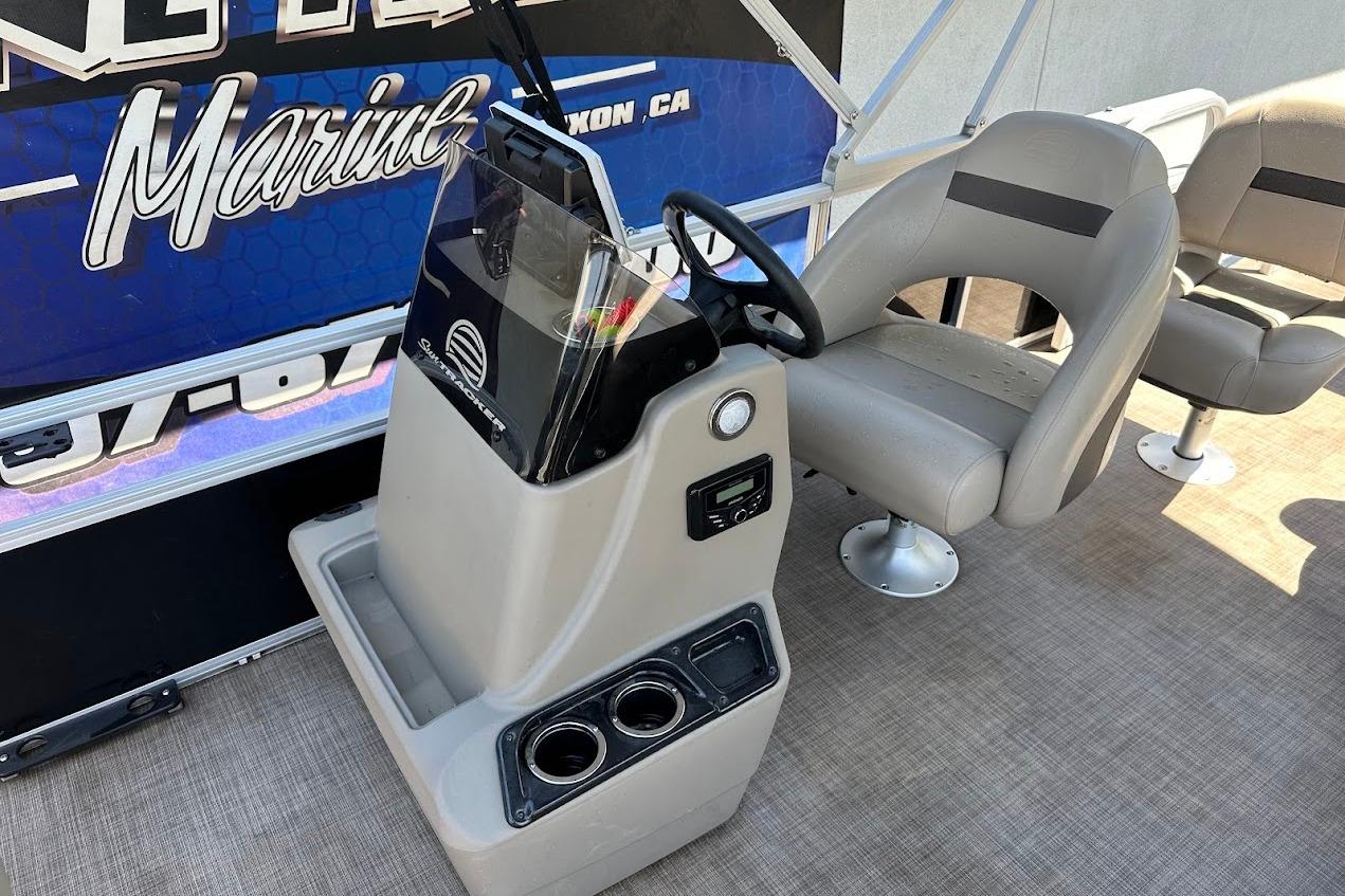 2022 Sun Tracker Bass Buggy 18 DLX pontoon boat interior with steering console and seating.