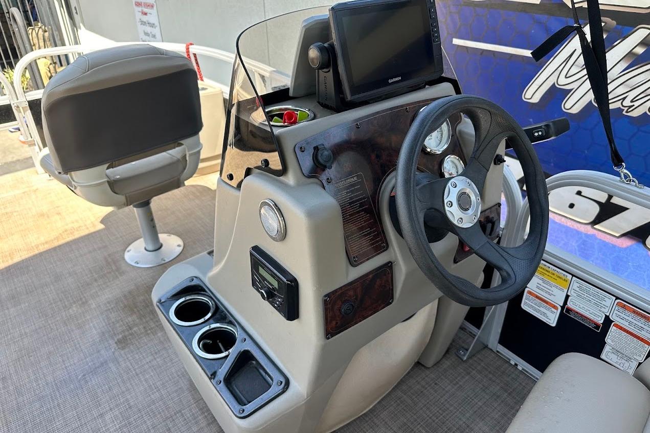 2022 Sun Tracker Bass Buggy 18 DLX boat dashboard with steering wheel and controls.