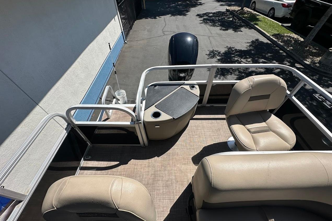 2022 Sun Tracker Bass Buggy 18 DLX pontoon boat interior with beige seating.