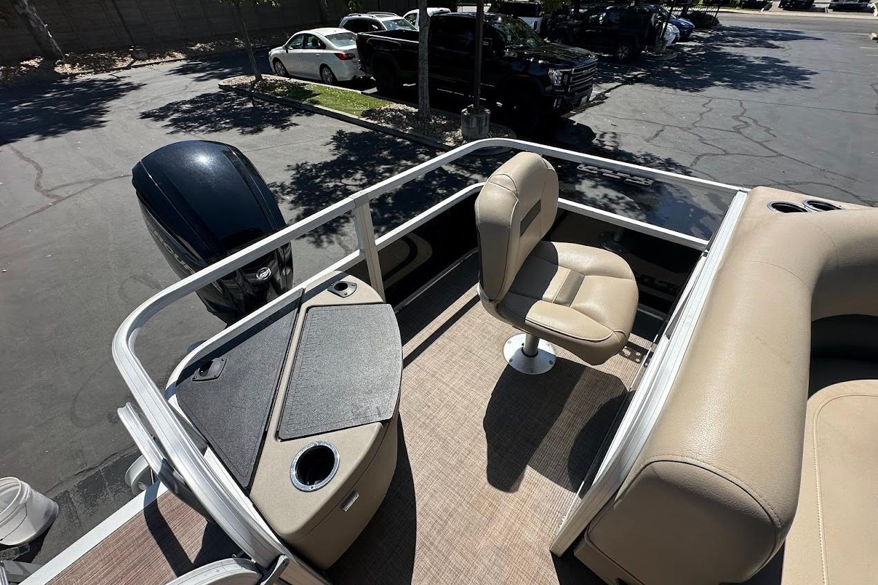 2022 Sun Tracker Bass Buggy 18 DLX pontoon boat interior with seating and motor.