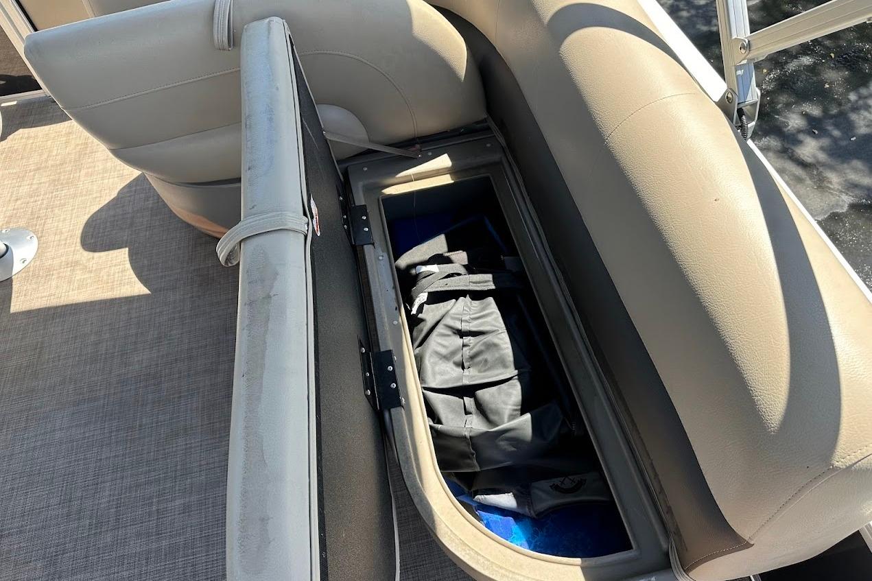 Open storage compartment on 2022 Sun Tracker Bass Buggy 18 DLX pontoon boat seat.