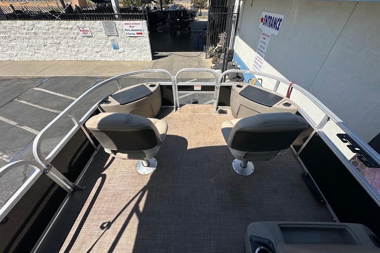 2022 Sun Tracker Bass Buggy 18 DLX pontoon boat interior with seating and railing.