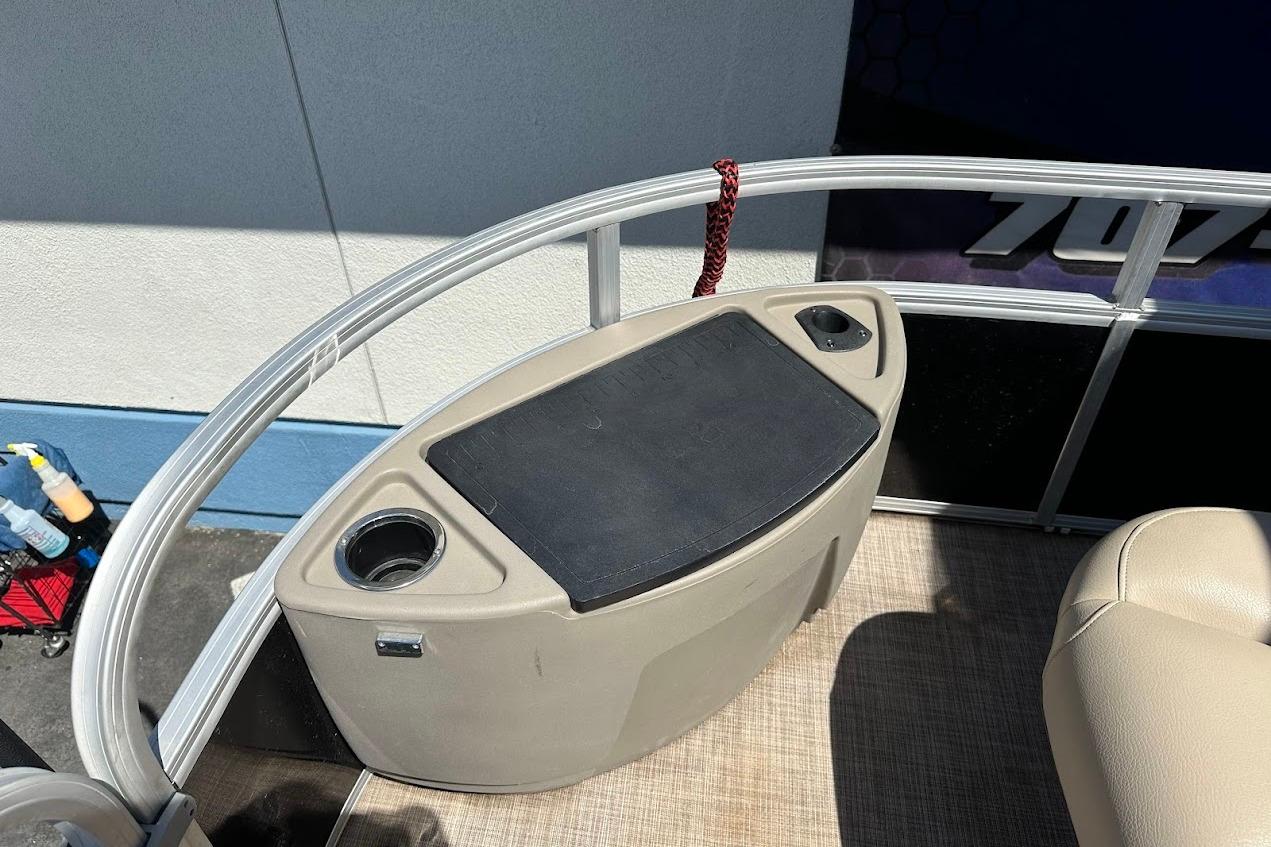 2022 Sun Tracker Bass Buggy 18 DLX boat interior with storage and cup holders.